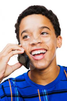 Happy teenage boy talking on a phone isolated over white