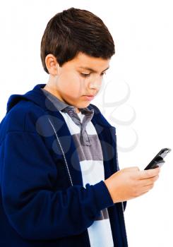 Boy text messaging with a mobile phone isolated over white