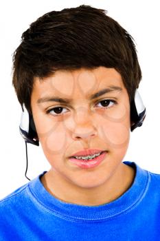 Portrait of a boy listening to music isolated over white