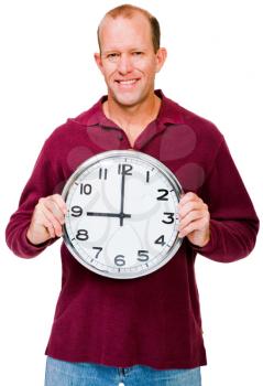 Happy mature man showing a clock isolated over white