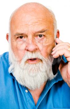 Angry man talking on a mobile phone isolated over white