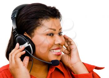 Smiling businesswoman using a headset isolated over white