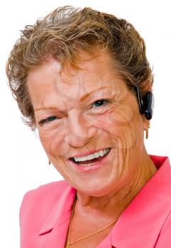 Close-up of a woman wearing a bluetooth and smiling isolated over white