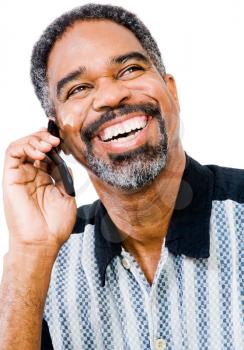 Close-up of a man talking on a mobile phone isolated over white