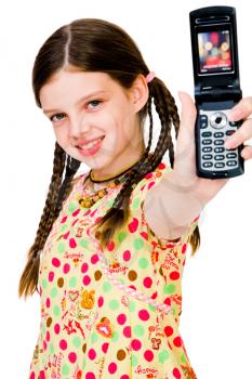 Smiling girl showing a mobile phone isolated over white