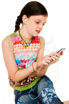 Happy girl listening to music on MP3 player isolated over white