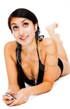 Middle Eastern woman listening to music on MP3 player isolated over white