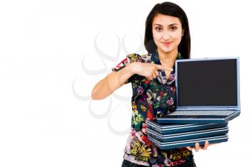 Young woman holding a stack of laptops isolated over white