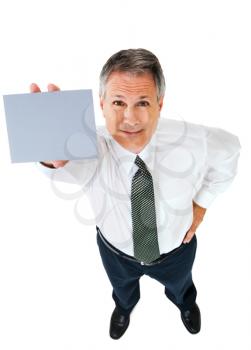 Businessman showing a placard and smiling isolated over white