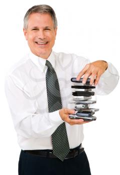 Portrait of a businessman holding a stack of phones isolated over white