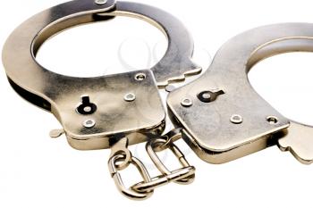 Close-up of handcuffs isolated over white