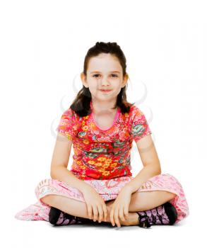 Smiling girl sitting on the floor isolated over white
