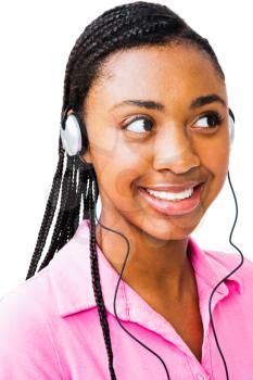 Teenager listening to music on headphones and smiling isolated over white