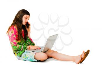 Beautiful girl using a laptop and a mobile isolated over white