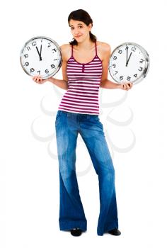 Confused woman holding clocks and posing isolated over white