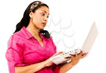 Surprised young woman using a laptop isolated over white