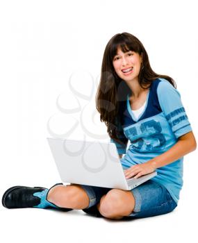 Confident teenage girl using a laptop and smiling isolated over white