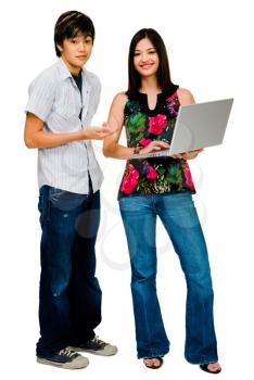 Woman using a laptop with her brother and smiling isolated over white