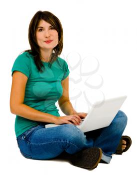 Fashion model using a laptop and smiling isolated over white