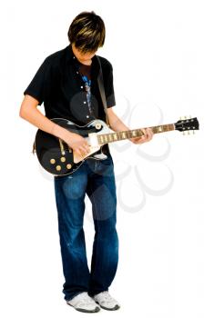 Teenage boy playing a guitar and posing isolated over white