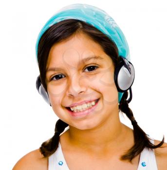 Mixedrace girl listening to music on a headphones isolated over white