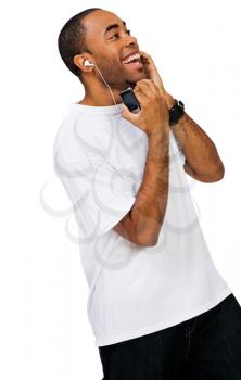 Smiling man listening to music on a MP3 player isolated over white