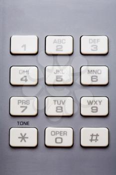 Gray color keypad of a landline phone isolated over white