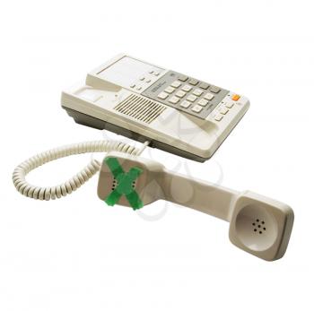 Landline phone with adhesive tape on it isolated over white