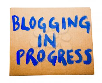 Blogging in progress text on a placard isolated over white