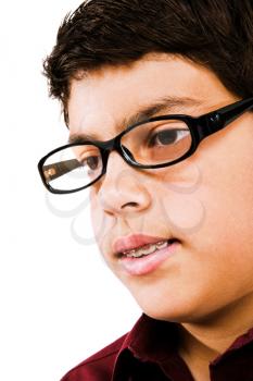 Boy wearing eyeglasses and thinking isolated over white