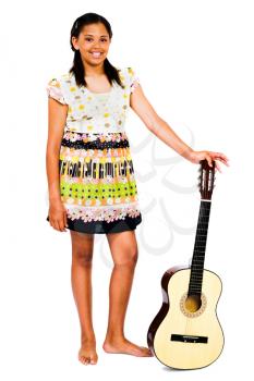 Teenage girl holding a guitar and smiling isolated over white