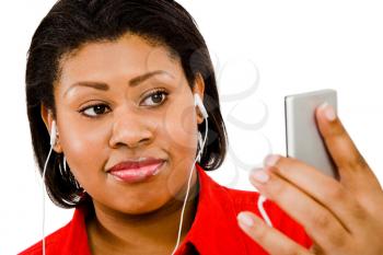 Happy woman listening to music on MP3 player isolated over white