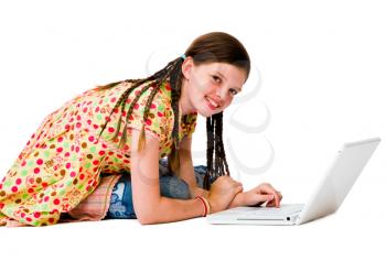 Caucasian girl using a laptop and smiling isolated over white