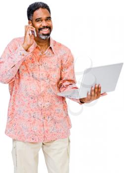 Portrait of a man using a laptop and a mobile isolated over white