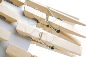 Clothespins attached with a card isolated over white