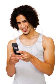Handsome man text messaging on a mobile phone isolated over white