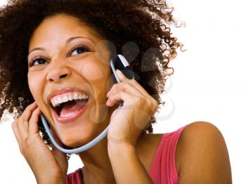Woman listening to music on headphones and smiling isolated over white