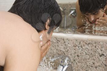 Man washing his face after shaving