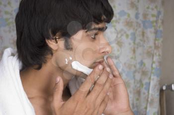Man applying shaving cream on his face