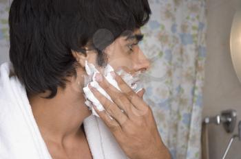 Man applying shaving cream on his face