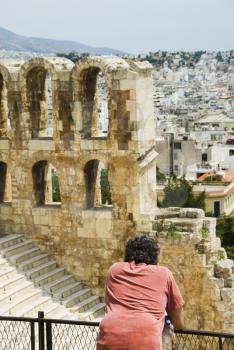 Tourist in an ancient amphitheater, Theatre of Dionysus, Acropolis, Athens, Greece