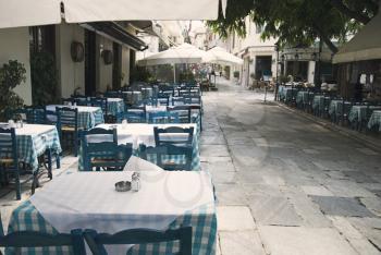 Tables and chairs at a sidewalk cafe, Athens, Greece