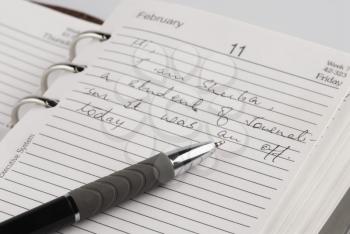 Close-up of a pen on a personal organizer