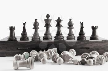 White chess pieces fell in front of black chess pieces