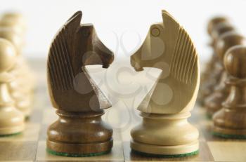 Close-up of chess knights face to face