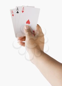 Close-up of a woman's hand holding playing cards