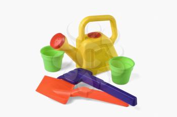Close-up of sand pails and shovels with watering can