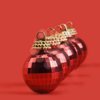 Close-up of five red baubles in a row