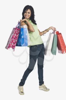 Woman carrying shopping bags and smiling