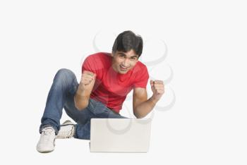 Man sitting in front of a laptop and smiling